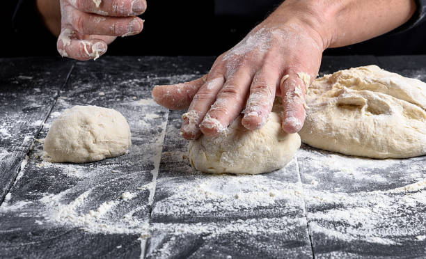 istock cook making dough balls on a black wooden table 1087318006