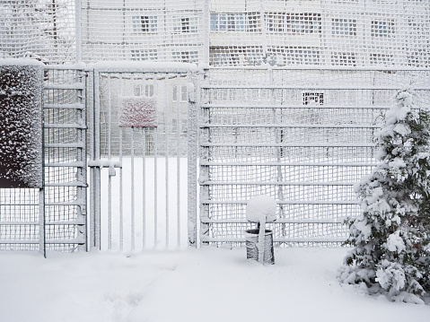 The door covered with snow. Snow-covered gate