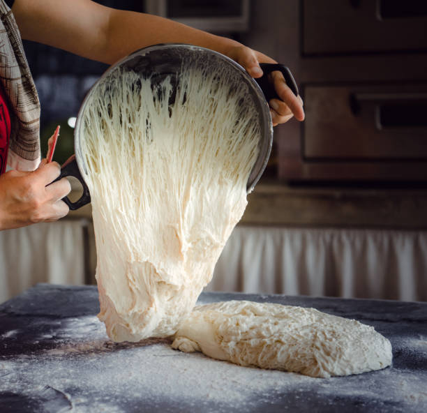 istock Bakery pouring bread dough onto table in Dali, Yunnan, China bakery. Copy Space. 1087318524