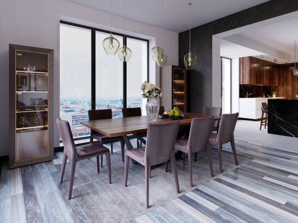 istock Panoramic windows in luxury dining room with wooden table and leather chairs next to showcase and designer hanging lamps. 1087318570