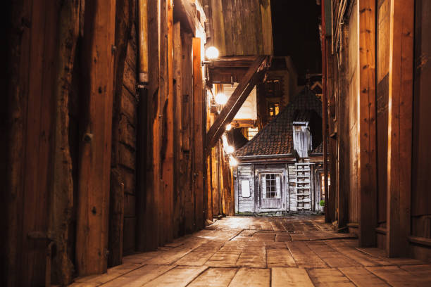 Bergen Bryggen street perspective at night. Traditional Norwegian wooden houses