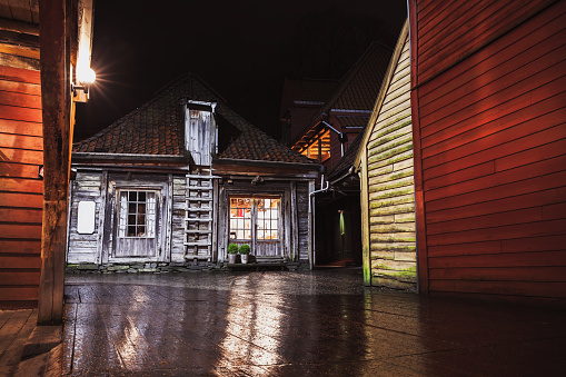 Bergen Bryggen night street view. Traditional Norwegian red wooden houses