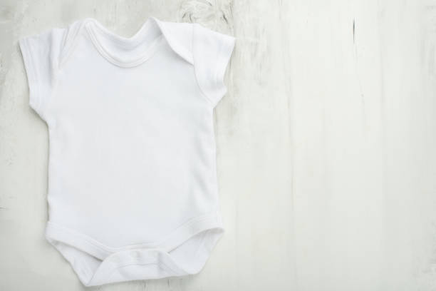 istock Layout Flat Lay a white baby body shirt on a white marble background. Layout for design and placement of logos, advertising 1087325852