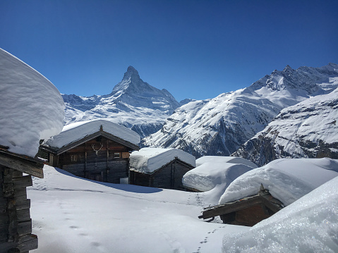 Beautiful winter landscape with snow covered cottages in front of Matterhorn mountain, Zermatt, Switzerland