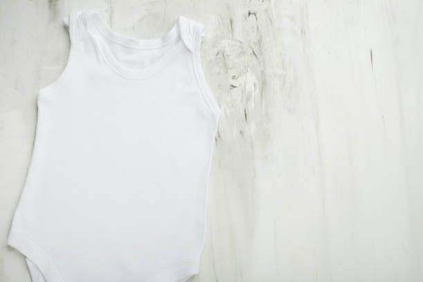 istock Layout Flat Lay a white baby body shirt on a white marble background. Layout for design and placement of logos, advertising 1087326694
