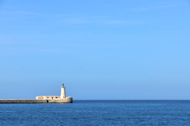 istock A lighthouse and breakwater in the sea, Malta 1087332202