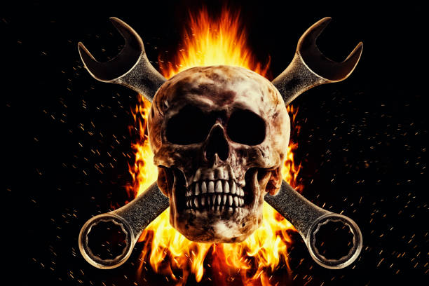 istock Skull and wrench in fire on a black background. 1087341820