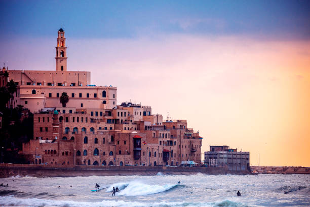 istock Jaffa sunset, surfers in action - Tel Aviv, Israel 1087346586