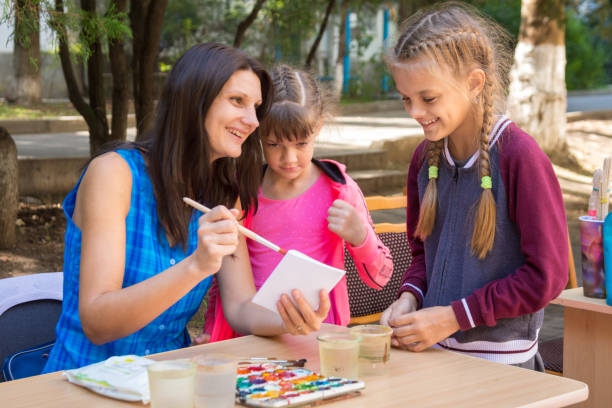 istock The teacher at the master class shows an example, cheerful laughter 1087353098