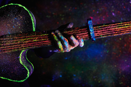 Christmas decoration. guitar painted with neon paint