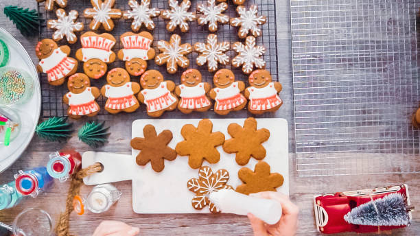 istock Decorating gingerbread cookies with royal icing. 1087371178