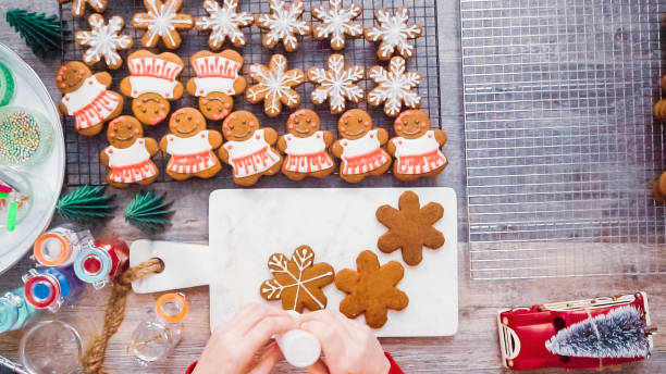 istock Decorating gingerbread cookies with royal icing. 1087371564