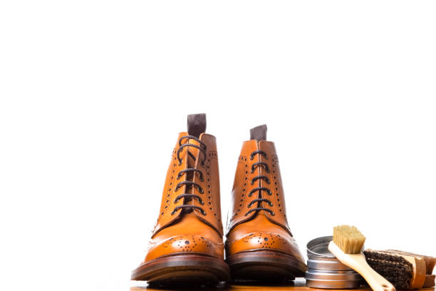 istock Mens Brogues Boots In Line With Cleaning Accessories on Shiny Table.Against White Background.Horizontal Image 1087371806
