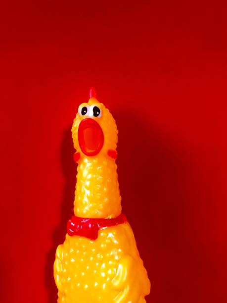 istock Yellow chicken toy shouting on red background 1087373742
