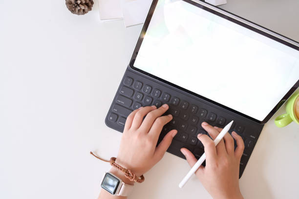 istock Top view man hand typing smart keyboard  tablet on white table in studio workplace 1087375414