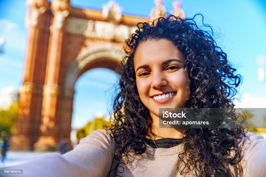 Hispanic tourist young woman taking a selfie at Arc de Triomphe Barcelona, Spain 20-29 Years Stock Photo