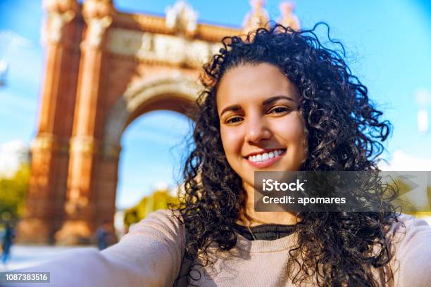 Hispanic Tourist Young Woman Taking A Selfie At Arc De Triomphe Barcelona Spain Stock Photo - Download Image Now