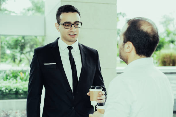 istock Confident young executive in glasses talking to his colleague 1087397846