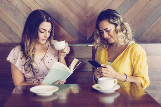 istock Two attractive young women drinking coffee and resting in cafe 1087401202