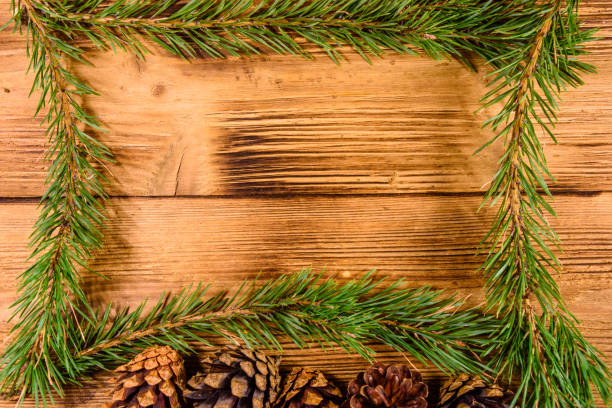 istock Frame of the fir tree branches on a wooden table 1087401594