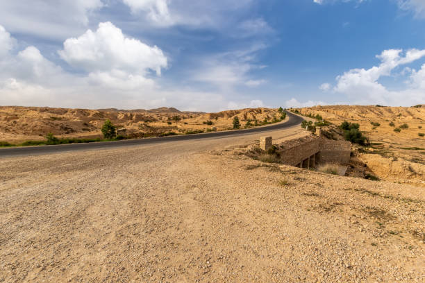 istock Road at Sahara desert in the afternoon. 1087415346