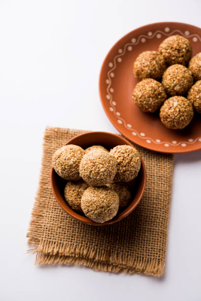 istock Tilgul Laddu or Til Gul balls for makar sankranti, it's a healthy food made using sesame, crushed peanuts and jaggery. served in a bowl. selective focus showing details. 1087416106
