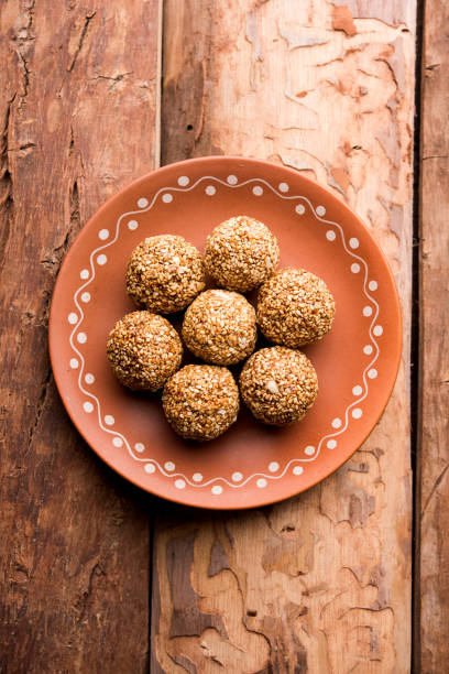 istock Tilgul Laddu or Til Gul balls for makar sankranti, it's a healthy food made using sesame, crushed peanuts and jaggery. served in a bowl. selective focus showing details. 1087416444