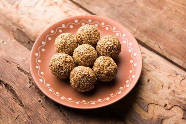 istock Tilgul Laddu or Til Gul balls for makar sankranti, it's a healthy food made using sesame, crushed peanuts and jaggery. served in a bowl. selective focus showing details. 1087417532
