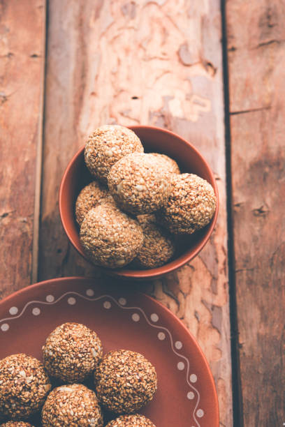 istock Tilgul Laddu or Til Gul balls for makar sankranti, it's a healthy food made using sesame, crushed peanuts and jaggery. served in a bowl. selective focus showing details. 1087417570