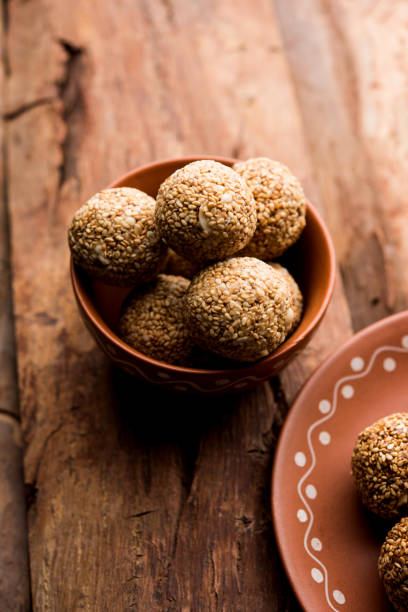 istock Tilgul Laddu or Til Gul balls for makar sankranti, it's a healthy food made using sesame, crushed peanuts and jaggery. served in a bowl. selective focus showing details. 1087417652