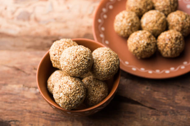 istock Tilgul Laddu or Til Gul balls for makar sankranti, it's a healthy food made using sesame, crushed peanuts and jaggery. served in a bowl. selective focus showing details. 1087418182
