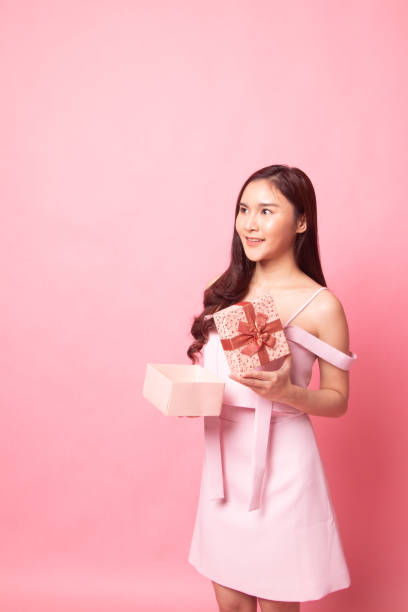 istock Young Asian woman open a gift box. 1087426554