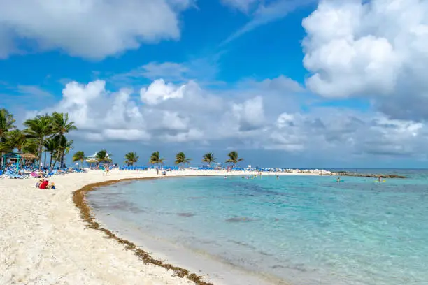 Cruise ship passengers enjoy a sunny day at the beach on tropical island CoCo Cay, Bahamas