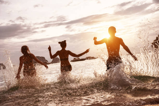 istock Happy friends sunset sea beach run 1087431834