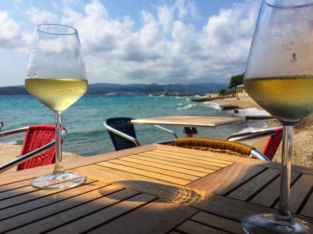 istock Two glasses white wine and sea 1087439560