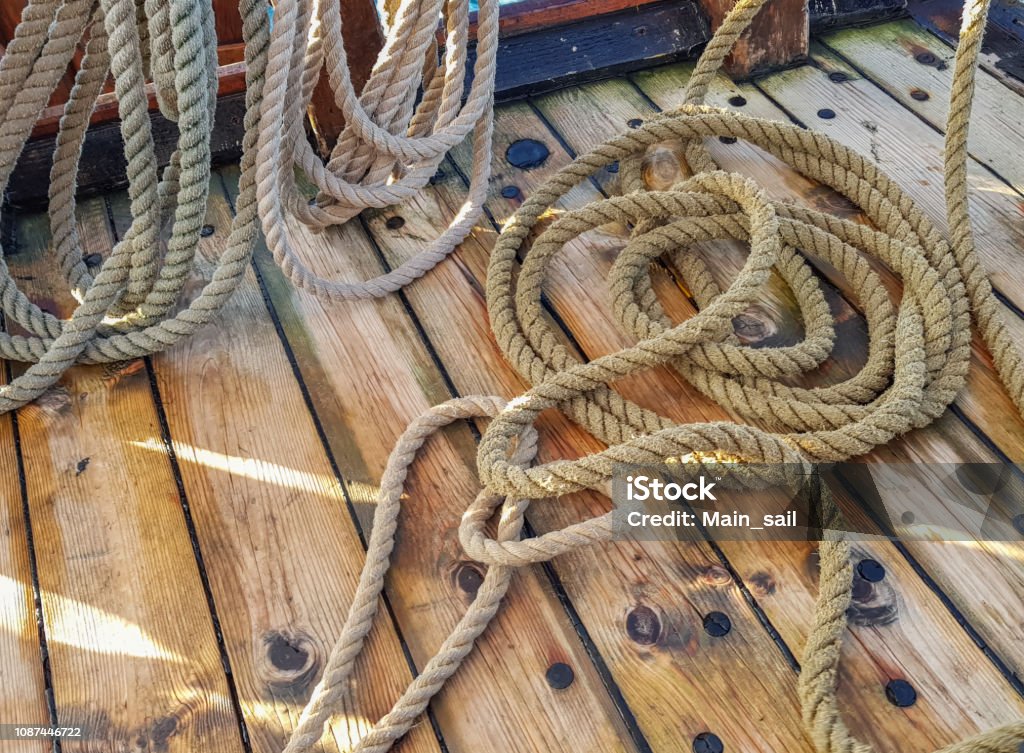 Thick Old Ropes On The Wooden Deck Of The Ship Stock Photo