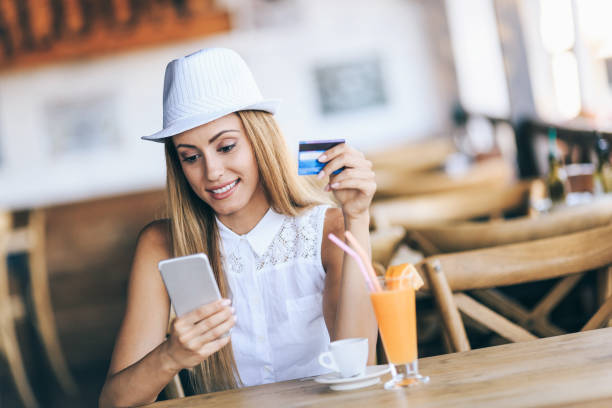 istock Girl with credit card and smart phone 1087448564