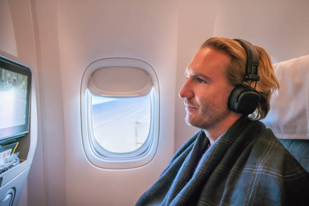 istock Airplane passenger enjoying onboard entertainment in comfortable seat 1087448802