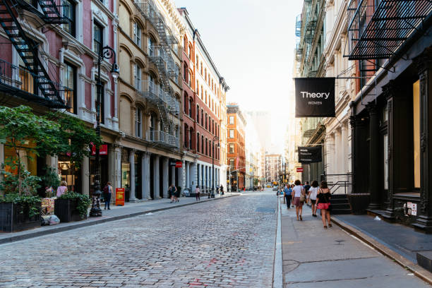 Typical street in Soho in New York New York City, USA - June 25, 2018: Greene Street with luxury fashion retail stores in Soho Cast Iron historic District in New York City. soho new york stock pictures, royalty-free photos & images