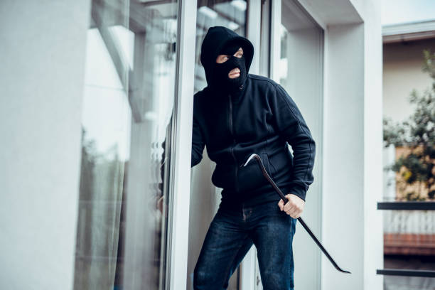 Robber Robber breaks house door burglar stock pictures, royalty-free photos & images