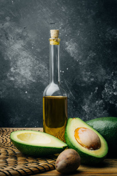 istock Avocado and avocado oil on a wooden background. Copy space. 1087459992