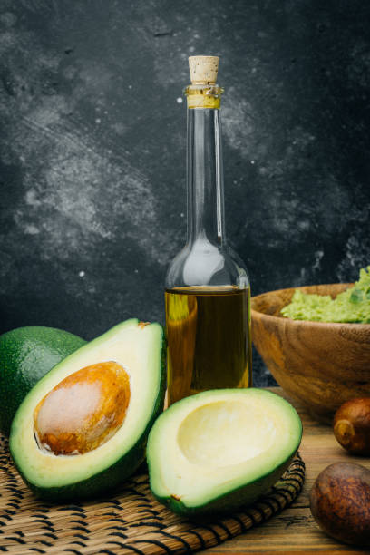 istock Avocado and avocado oil on a wooden background. Copy space. 1087459998