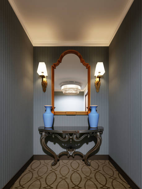istock Classic wooden console with a mirror in a gold frame on the wall and decorative blue vases. 1087461842