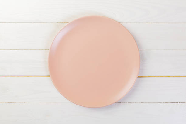 istock Directy above Empty rose matte dish for dinner on white wooden background 1087462580