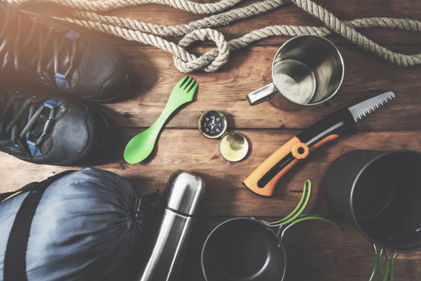istock expedition camping equipment on wooden plank background. top view 1087464446