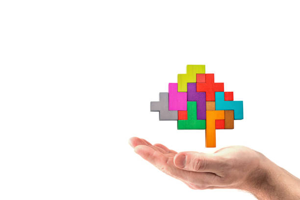 istock Human hand holding abstract brain. Human brain is made of multi-colored wooden blocks. 1087469912