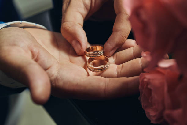 istock man holding wedding rings, groom getting ready in the morning before ceremony 1087478208