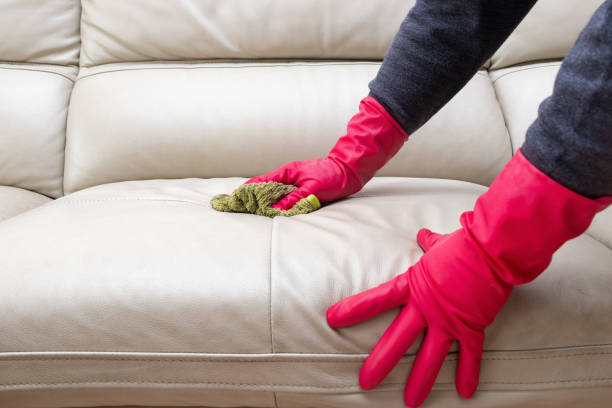 istock side view man cleaning leather sofa at home with wet towel 1087482070