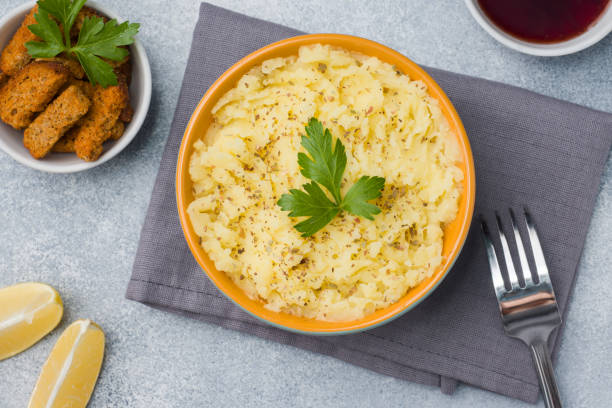 istock Mashed potatoes with herbs, croutons and lemon in a plate on napkins. 1087484464