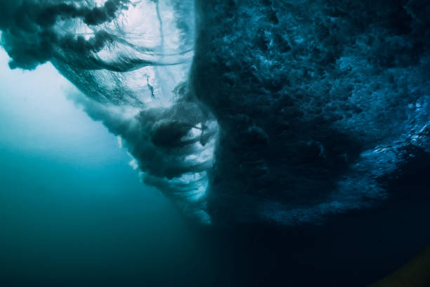 istock Underwater texture. Blue barrel wave crashing in ocean. 1087486540